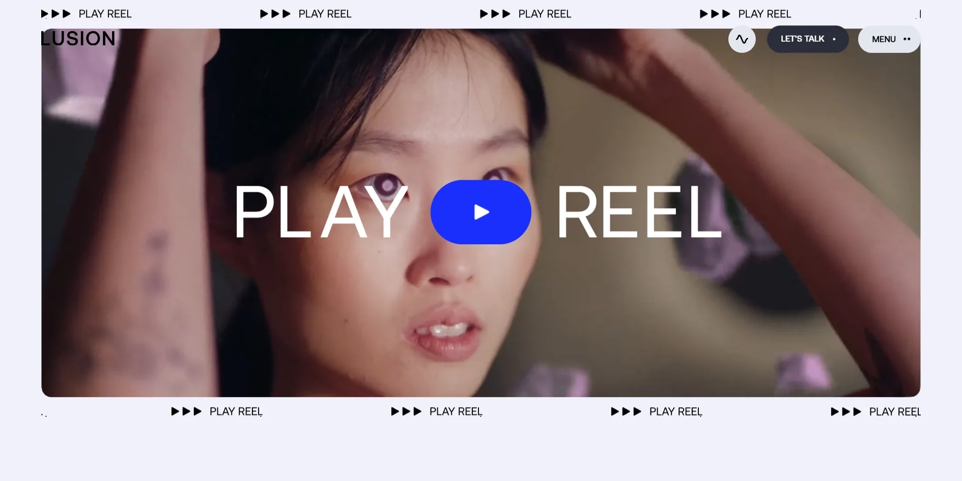 The cursor rests on the play button, which has turned blue, and the small crosses above and below the film have been replaced by two strips of three play arrows and PLAY REEL