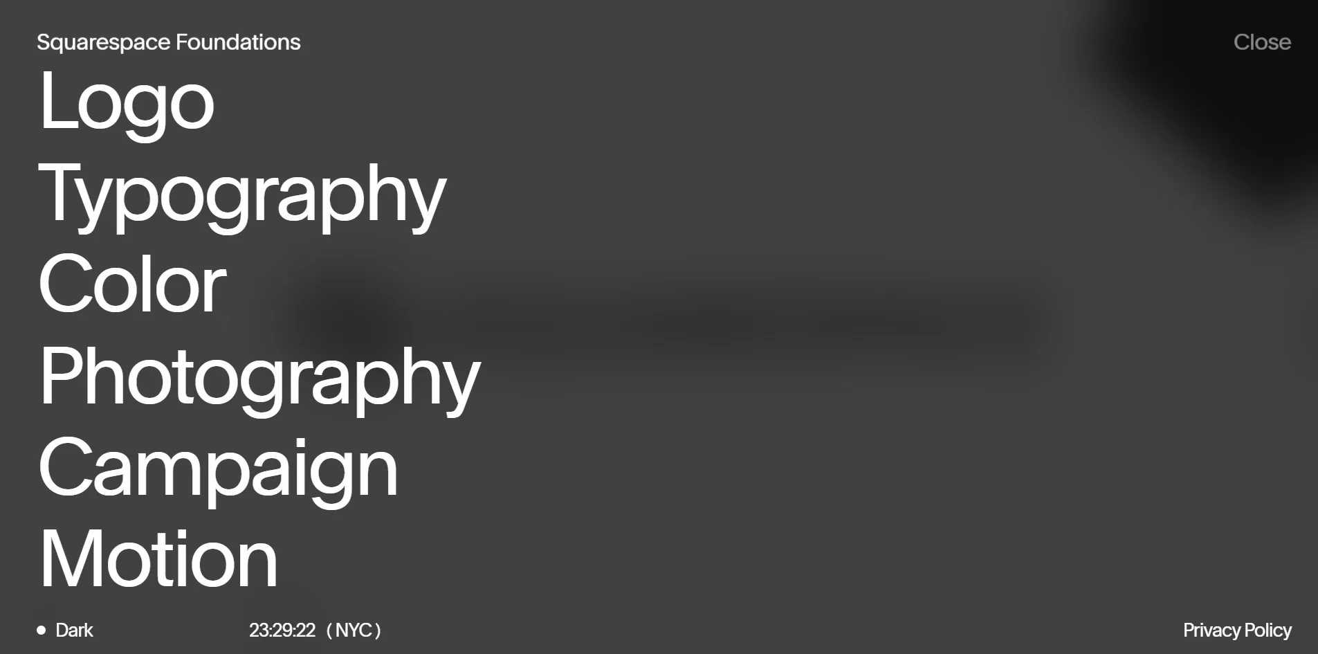 The Index: six chapter names over a blurred view of the current screen, with New York time below
