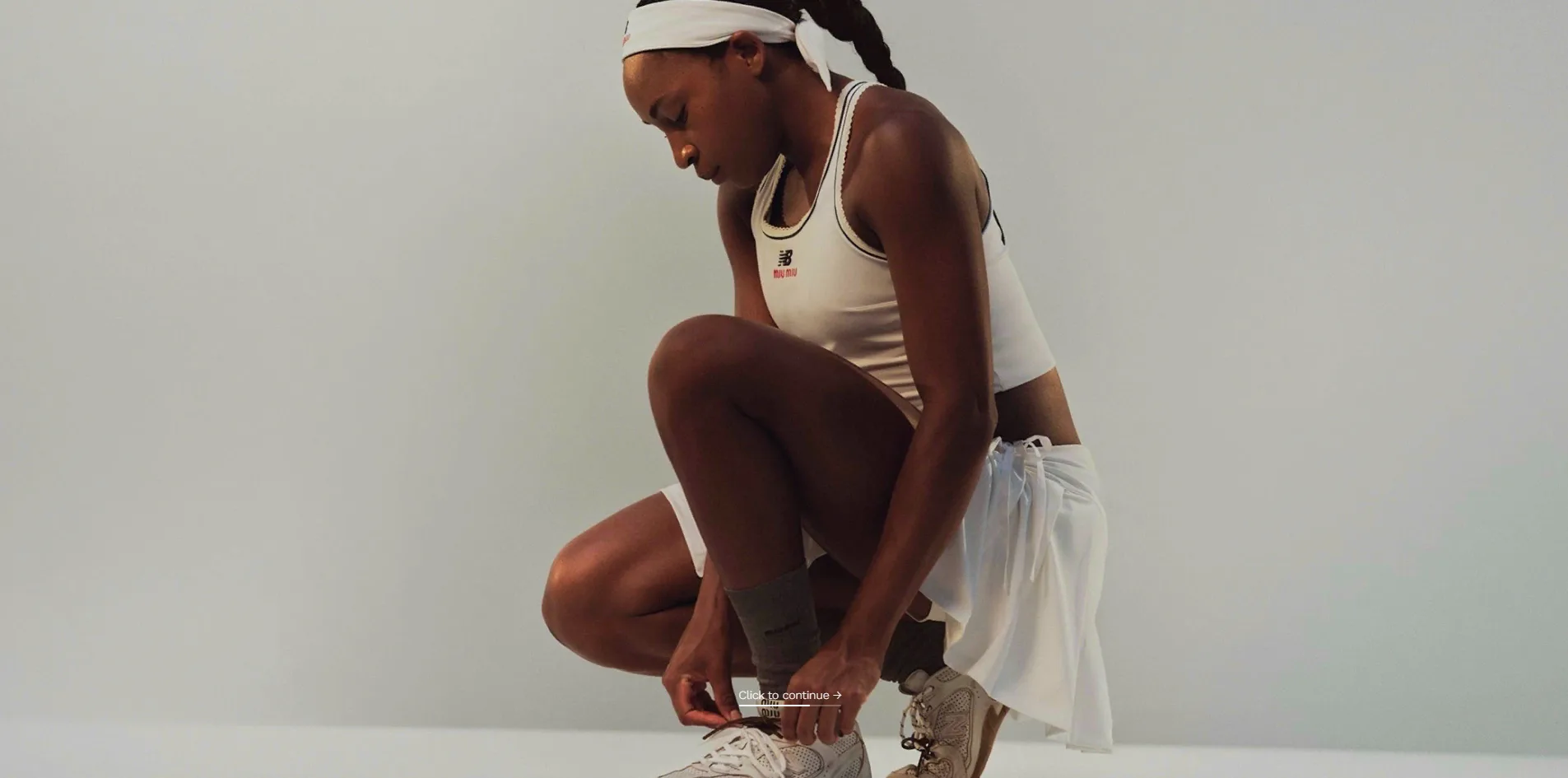 Once the photograph is fully revealed, Coco Gauff crouches in white tennis clothes against a grey background tying her laces, with nothing else on screen but a line reading Click to continue and a thin rule beneath it.