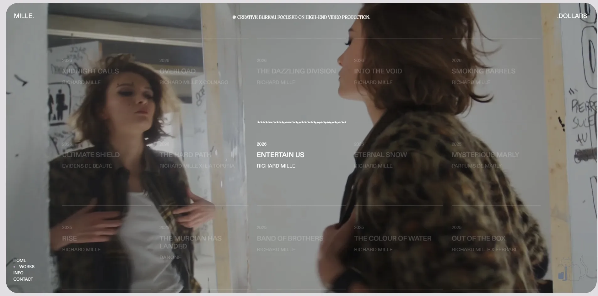 On the works page the cursor rests on Entertain Us, and that film fills the page behind the text, showing two actresses in front of a graffiti wall while the other entries have faded to translucent