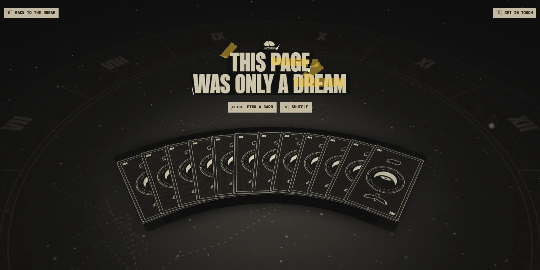 On a dark table a deck of cards with an eye and a crow on their backs is fanned out, the title THIS PAGE WAS ONLY A DREAM is stuck above it, and the prompts CLICK PICK A CARD and S SHUFFLE sit below
