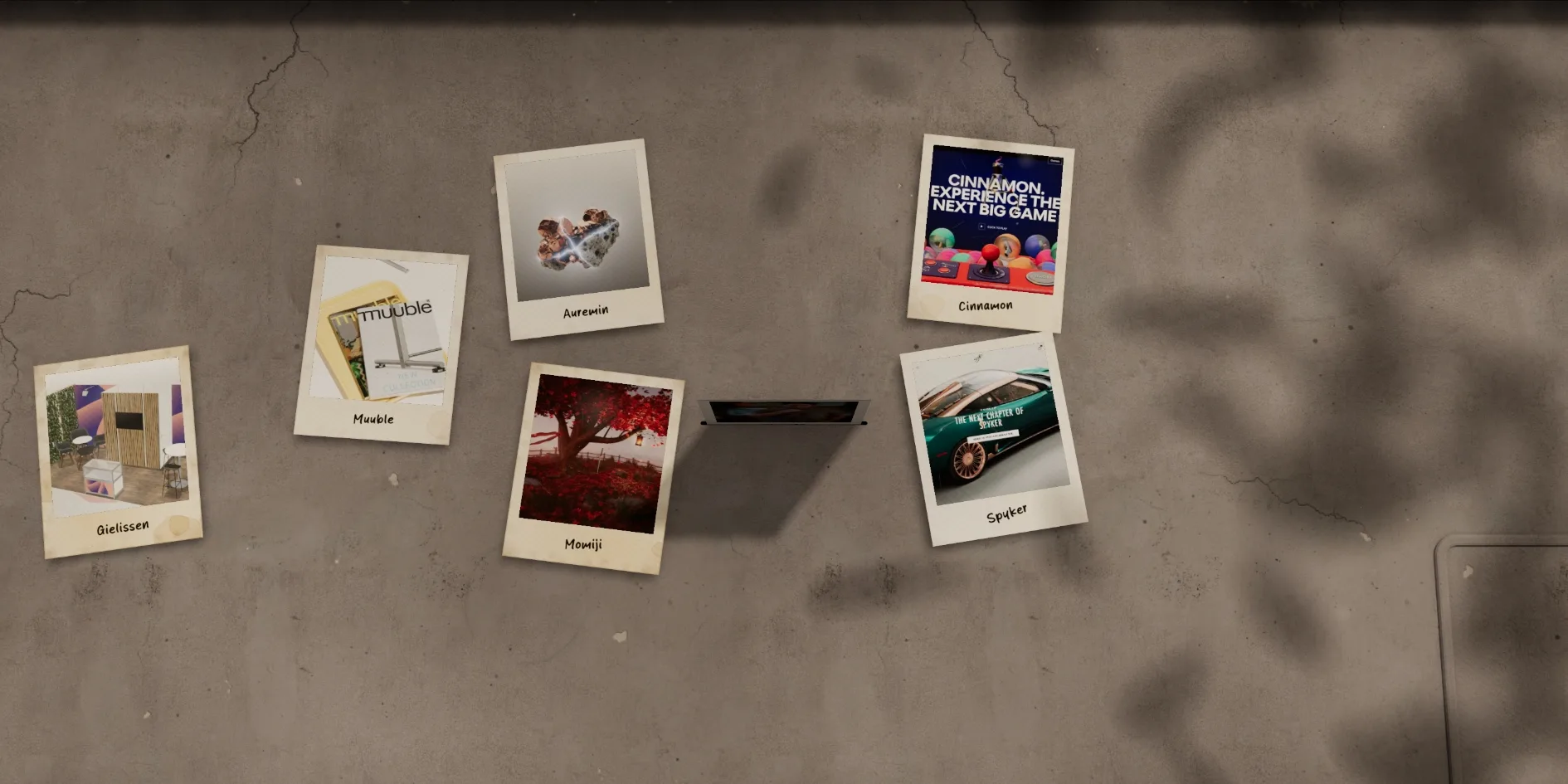 The last moment of the opening, with the camera still close to the table, six project photos in a ring and one photo in the middle falling edge first towards the table