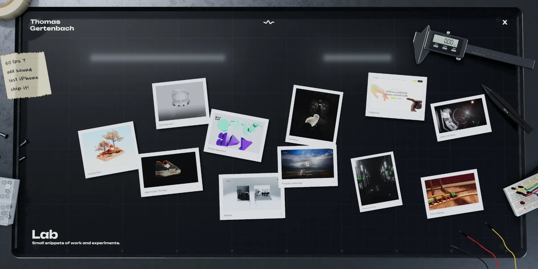 The dark cutting mat on the Lab page, with eleven experiment photos scattered across it, a caliper, tweezers, wires and a breadboard around the edges and a sticky note at the top left reading 60 fps? add sound test iPhone ship it!